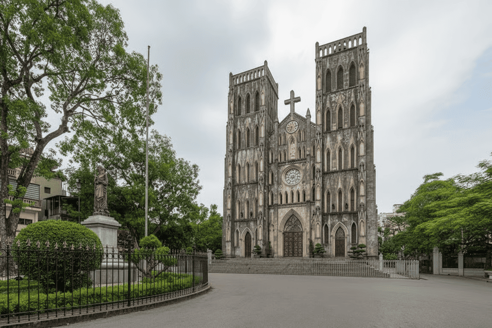 Hanoi St. Joseph Cathedral bathed in golden sunlight and framed by lush greenery
